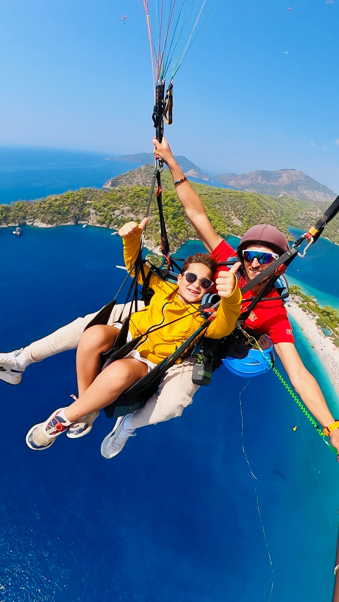 Tandem paragliding flight with instructor over Fethiye coastline
